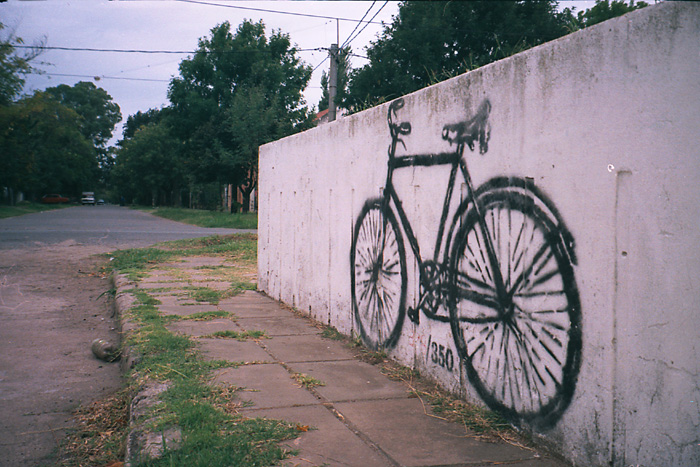 graffiti of a bicycle painted on a cement wall